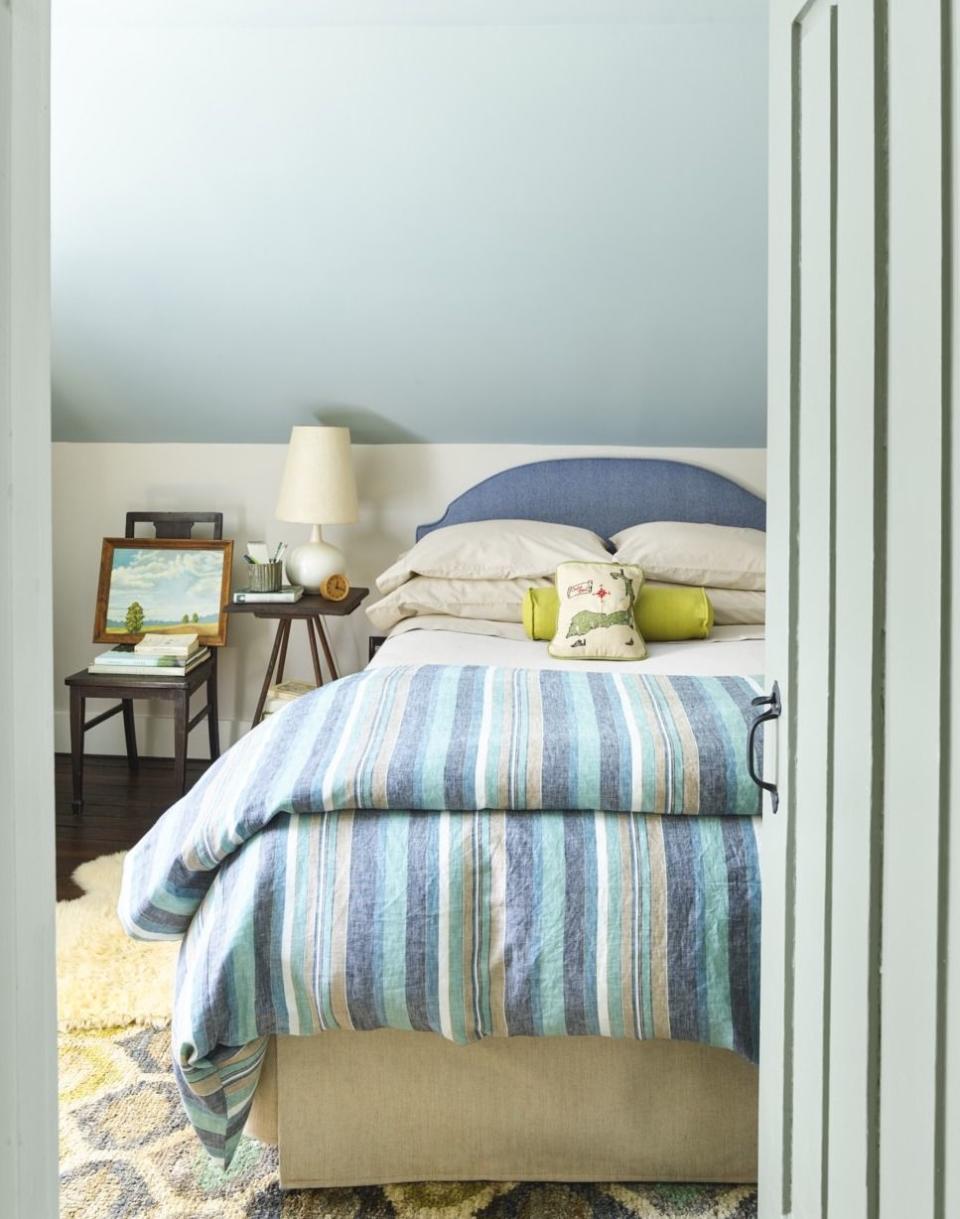 <p>Emphasize the slope and height of a low ceiling with a peaceful blue paint color. <a href="https://www.benjaminmoore.com/en-us/color-overview/find-your-color/color/716/fantasy-blue?color=716" rel="nofollow noopener" target="_blank" data-ylk="slk:Fantasy Blue by Benjamin Moore;elm:context_link;itc:0;sec:content-canvas" class="link ">Fantasy Blue by Benjamin Moore</a> takes this bedroom ceiling to new heights in a charming Cape Cod cottage. </p>