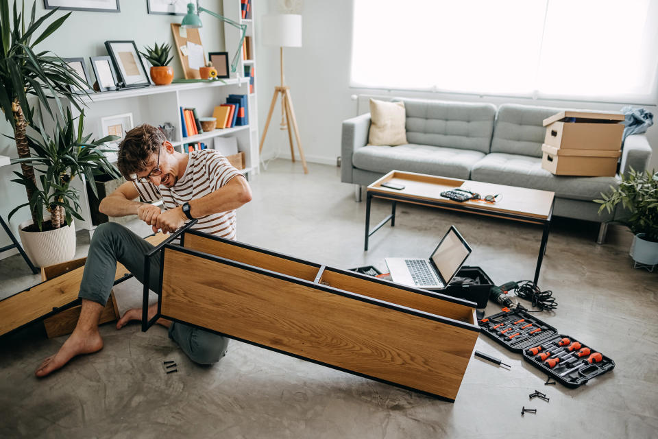 A person putting together furniture for their home