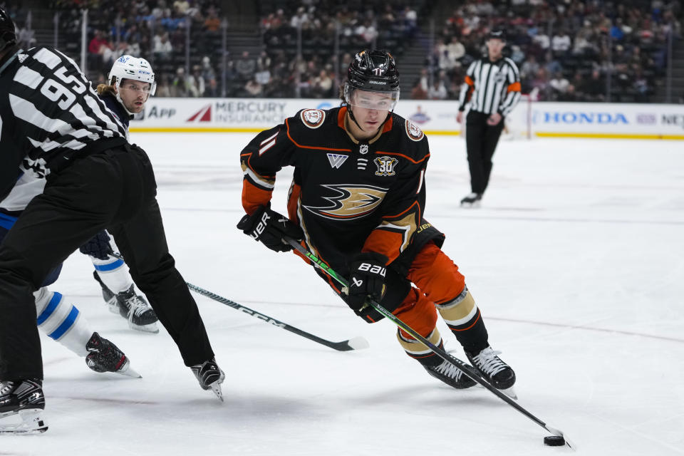 Anaheim Ducks center Trevor Zegras controls the puck during the first period of the team's NHL hockey game against the Winnipeg Jets on Friday, Jan. 5, 2024, in Anaheim, Calif. (AP Photo/Ryan Sun)