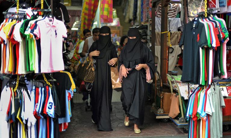 Tourists from the Middle East shopping in the popular tourist spot Petaling Street in downtown Kuala Lumpur