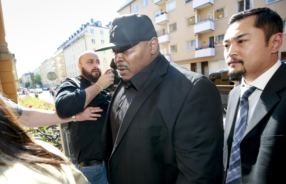 One of A$AP Rocky's bodyguards arrives at the district court in Stockholm, Friday Aug. 2, 2019, the third day of A$AP Rocky's trial. American rapper A$AP Rocky testified Thursday at his assault trial that he did everything possible to avoid a confrontation with two men he said were persistently following his entourage in Stockholm, but one of those men picked a fight with one of his bodyguards. (Fredrik Persson/TT via AP)