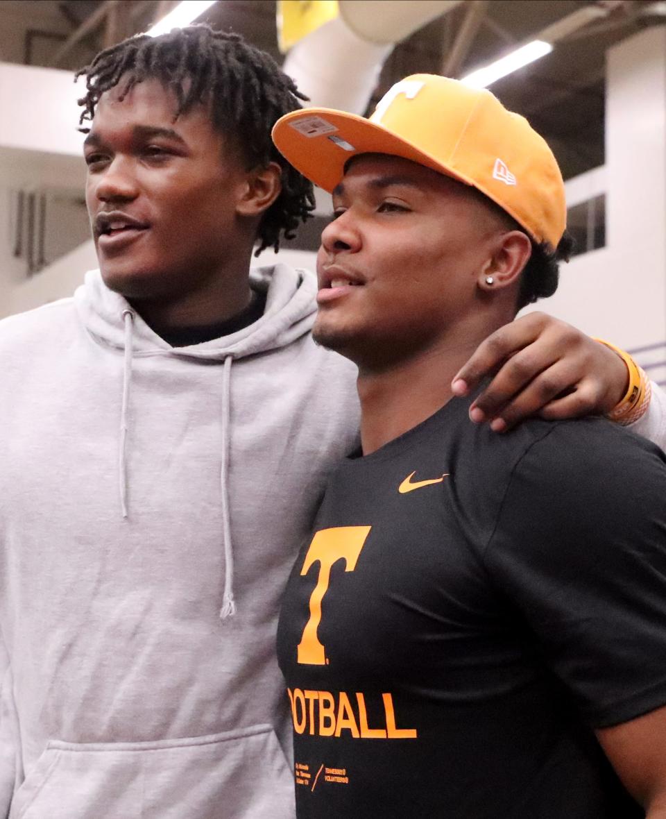 Riverdale football senior Caleb Herring, left, who will be playing at the University of Tennessee, came to Smyrna commitment celebration to see where Smyrna football senior Arion Carter, right, decided to go to college and play football during Carter's announcement at Smyrna High School on Wednesday, Dec. 14, 2022. Carter put on the University of Tennessee cap to show his choice during a football commitment celebration at Smyrna High School.