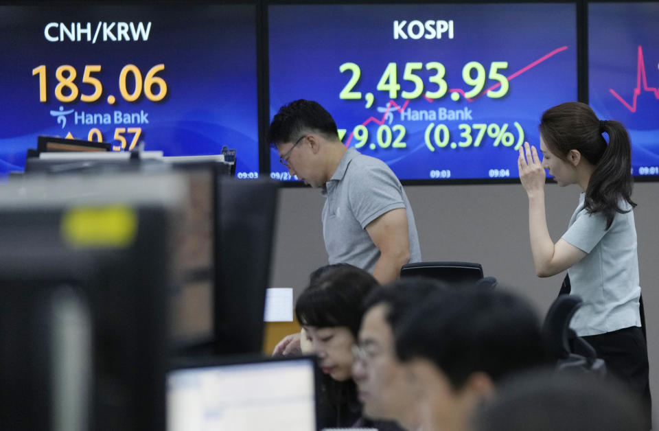 Currency traders walk by screens showing the Korea Composite Stock Price Index (KOSPI), right, at the foreign exchange dealing room of the KEB Hana Bank headquarters in Seoul, South Korea, Wednesday, Sept. 27, 2023. Shares in Asia were mostly lower on Wednesday after Wall Street’s ugly September got even worse, with benchmarks dropping back to where they were in June. (AP Photo/Ahn Young-joon)