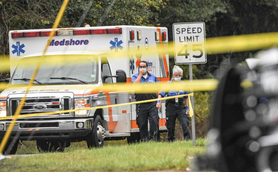 Medshore Ambulance workers wear masks at the scene where Anderson County Sheriff Deputies investigate and work the scene of a shooting homicide US 29 and Griffin Road Belton, S.C. Monday, October 4, 2021.  