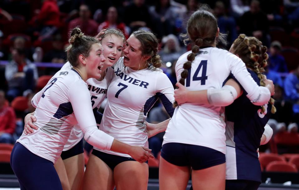 Xavier players celebrate after a point during the WIAA Division 2 state final against Sauk Prairie High School on Nov. 5, 2022, at the Resch Center in Ashwaubenon, Wis.