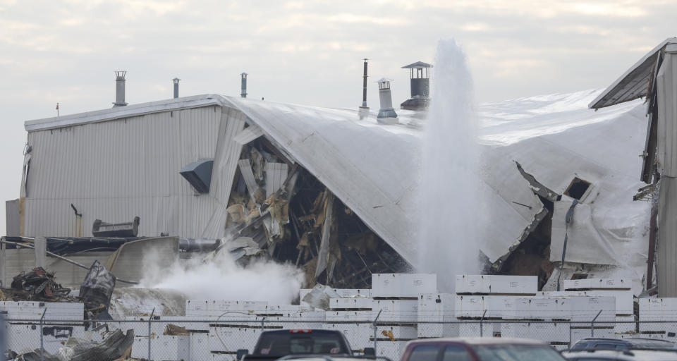 Authorities respond after a partial building collapse at Beechcraft aircraft manufacturing facility in Wichita, Kan., Friday, Dec. 27, 2019. More than a dozen people were injured Friday when a nitrogen line ruptured at the facility, causing part of the building to collapse, authorities said. (Travis Heying/The Wichita Eagle via AP)