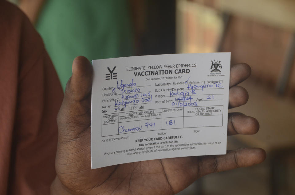 A man holds a vaccination card that proves he has received the yellow fever vaccine, at Kiswa Health Center III in Kampala, Uganda Tuesday, April 2, 2024. Uganda has rolled out a nationwide yellow fever vaccination campaign to help safeguard its population against the mosquito-borne disease that has long posed a threat. (AP Photo)