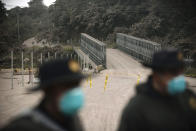 <p>Police block a route affected by the ash expelled by Volcan de Fuego, or Volcano of Fire, in El Rodeo, Guatemala, June 3, 2018. (Photo: Santiago Billy/AP) </p>