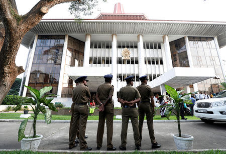 Sri Lankan Police stand guard in front of the Supreme Court while party members of the deposed Prime Minister Ranil Wickremesingehe-led United National Party handover a petition against the President Maithripala Sirisena's decision to sack the parliament, in Colombo, Sri Lanka November 12, 2018. REUTERS/Dinuka Liyanawatte