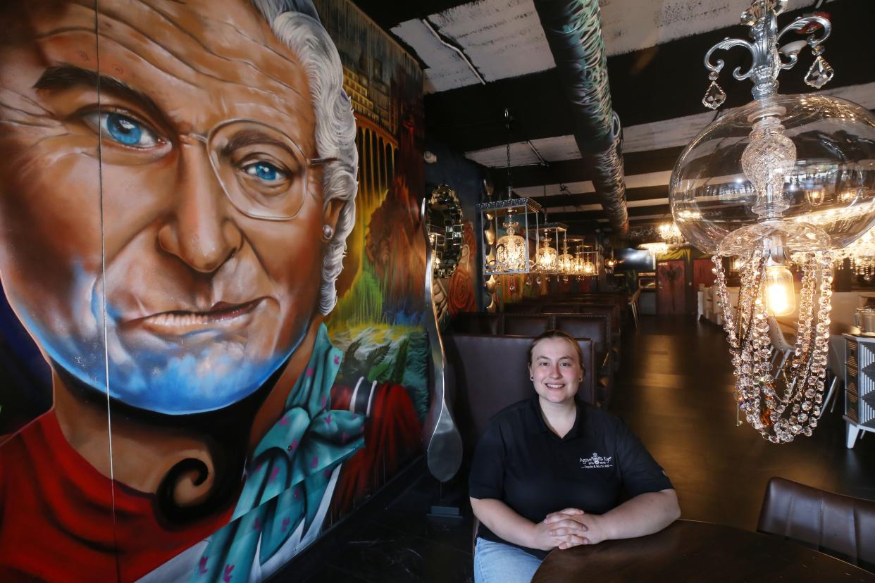Abby Starr, a dining room leader, sits in the Agave & Rye restaurant, 1295 Grandview Ave. on June 28. The restaurant opened June 22 and is adorned with a variety of art.