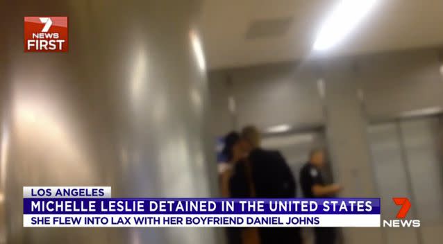 Leslie appeared to have an issue at an automated passport kiosk. After a quick kiss, Johns left Leslie with an officer who escorted her away. Photo: 7 News