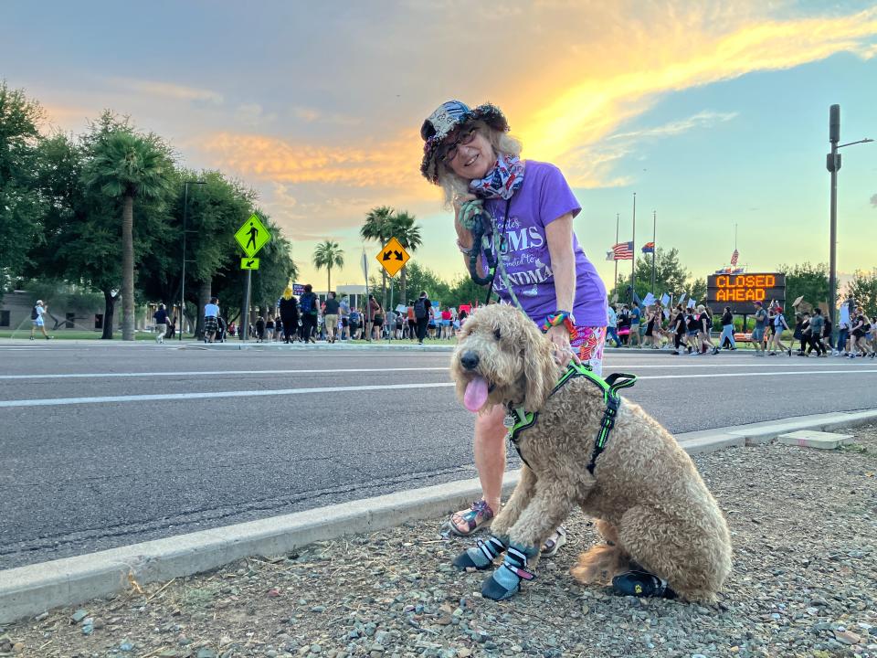 Karina Colbert and her dog at the march for abortion rights outside the Arizona Capitol on June 24, 2022.