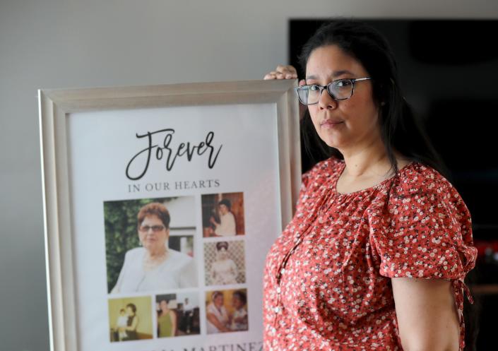 Vivian Zayas of Deer Park, Long Island holds a framed montage of photos of her mother Ana Martinez May 11, 2022. Ana Martinez, 78, died in March of 2020 after contracting COVID-19 during what was to have been a temporary stay a nursing home following knee surgery. Zayas has founded Voices for Seniors, a nonprofit that advocates for residents of nursing homes and their families.