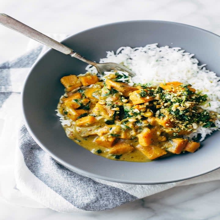 A bowl with white rice and vegetable curry