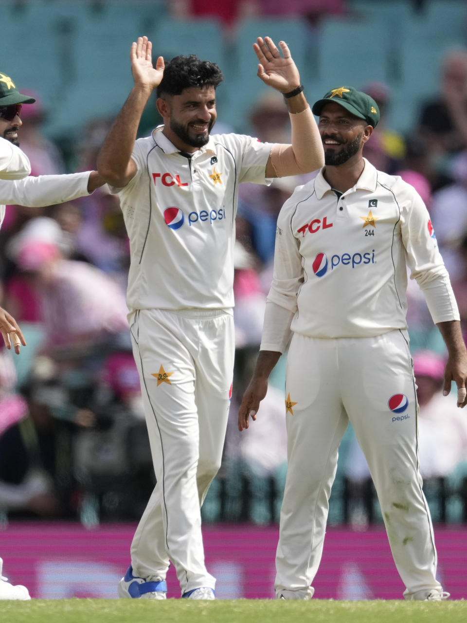 Pakistan's Aamer Jamal, center, celebrates taking the wicket of Australia's Nathan Lyon on the third day of their cricket test match in Sydney, Friday, Jan. 5, 2024. (AP Photo/Rick Rycroft)