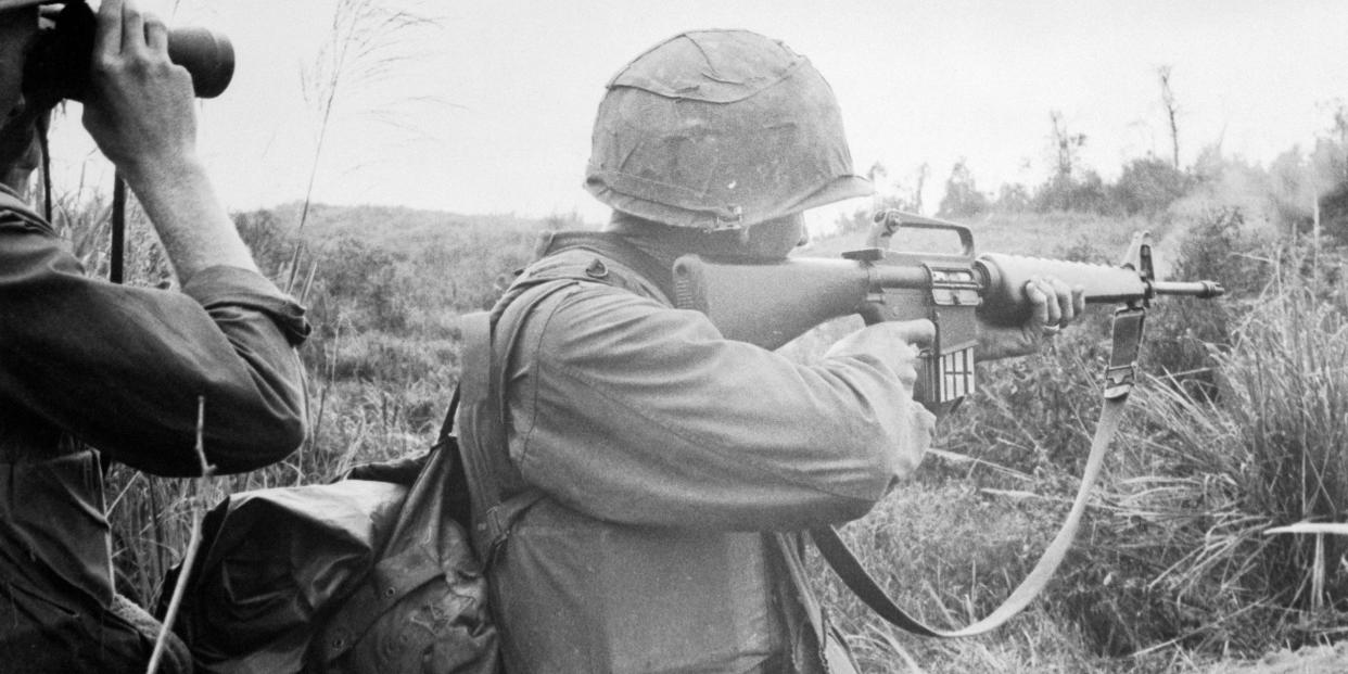 A Marine takes aim with a M16 rifle during an operation in Vietnam.