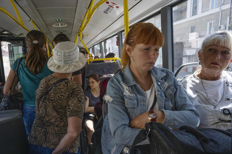 People wait on an evacuation bus, in Kramatorsk, eastern Ukraine, Tuesday, July 19, 2022. Donetsk Pavlo Kyrylenko said four Russian strikes had been carried out on the city of Kramatorsk, and he urged civilians to evacuate. (AP Photo/Nariman El-Mofty)