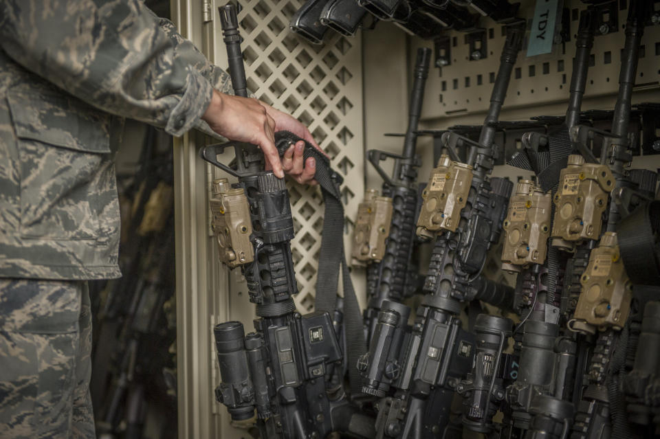 In this April 2, 2015, photo made available by the U.S. Air Force, a senior airman from the 49th Security Forces Squadron in charge of the armory, returns an M4 carbine to a rack at Holloman Air Force Base, N.M. The Pentagon used to share annual updates about missing weapons with Congress, but that requirement ended and, with it, public accountability has slipped. The Army and Air Force couldn’t readily tell AP how many weapons they were missing from 2010 through 2019. (Airman 1st Class Aaron Montoya/U.S. Air Force via AP)