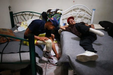 Migrants who lost legs attend a rehabilitation program