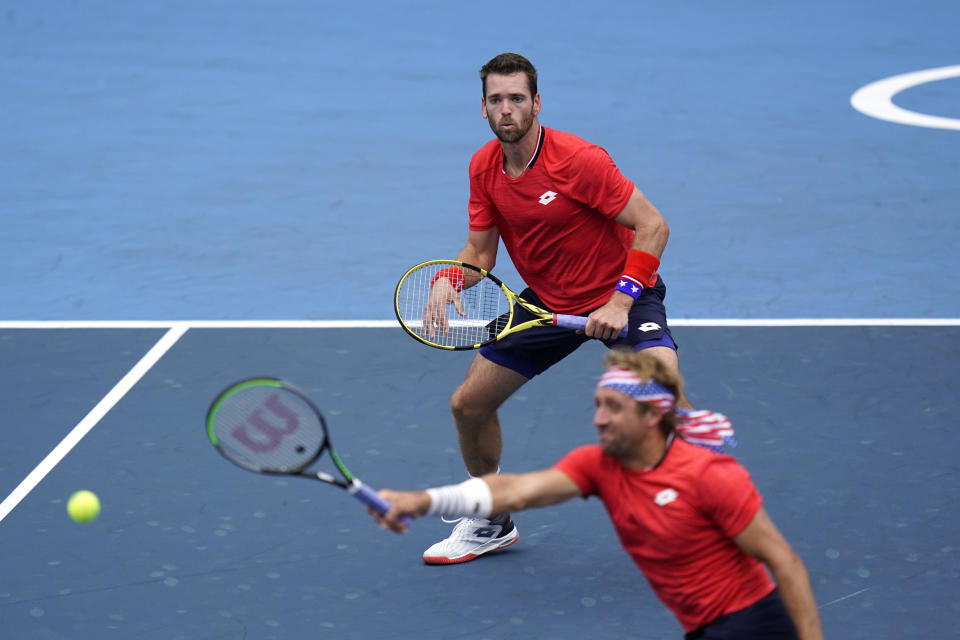 The United States doubles team of Tennys Sandgren, bottom, and Austin Krajicek play during the men's doubles bronze medal match of the tennis competition at the 2020 Summer Olympics, Friday, July 30, 2021, in Tokyo, Japan. (AP Photo/Seth Wenig)