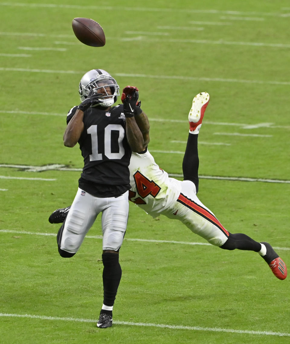 Las Vegas Raiders wide receiver Rico Gafford (10) misses a catch while guarded by Tampa Bay Buccaneers cornerback Carlton Davis (24) during the second half of an NFL football game, Sunday, Oct. 25, 2020, in Las Vegas. (AP Photo/David Becker)