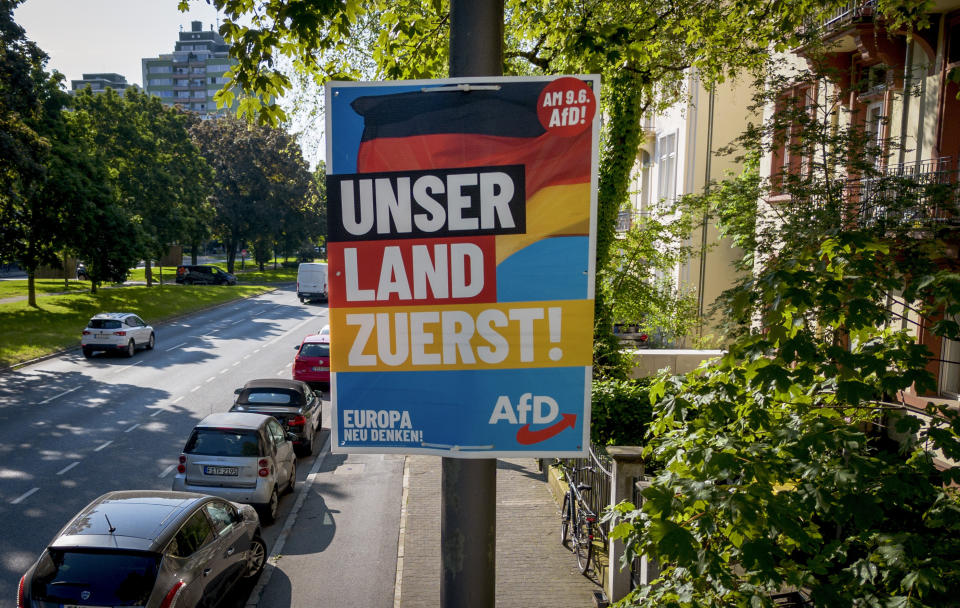 FILE - An AfD election poster for the European elections reading "our country first" is fixed on a pole in Frankfurt, Germany, Monday, May 13, 2024. Germany gets the 2024 European Championship underway against Scotland in Munich on Friday. However, away from the stadiums and public-viewing areas, few German flags are flying. Germany's dark history, rising far-right cast shadow on national pride before it hosts Euro 2024. (AP Photo/Michael Probst), File)