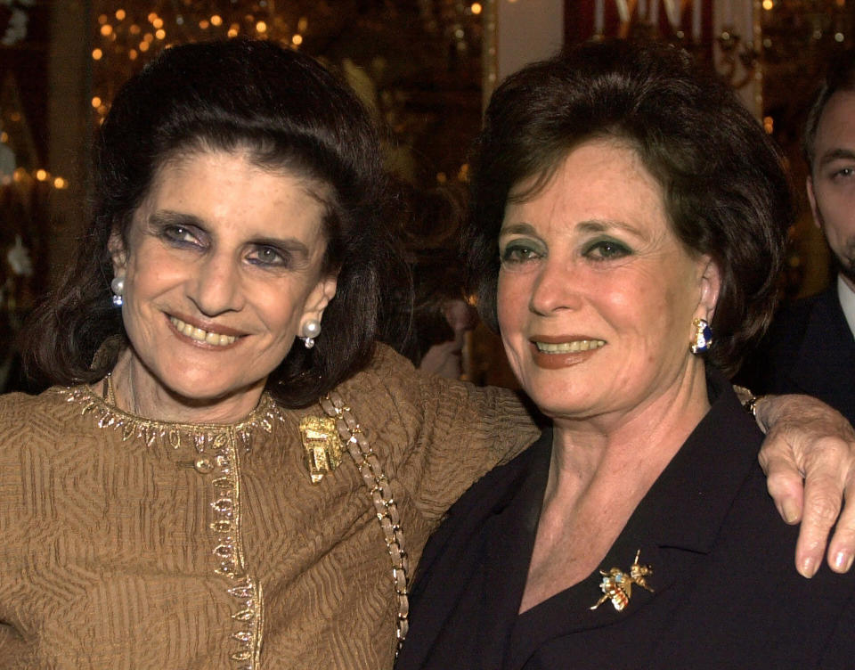 FILE - In this May 22, 2000, file photo, Leah Rabin, left, widow of slain Israeli Prime Minister Yitzhak Rabin, poses with Jehan Sadat, widow of assassinated Egyptian President Anwar Sadat at a reception before being honored at the "Broadway Salutes Seeds of Peace and the Peacemakers" gala at New York's Carnegie Hall. Jehan Sadat died in Cairo on Friday, July 9, 2021, at the age of 87, Egypt’s President’s office said. (AP Photo/Ron Frehm, File)