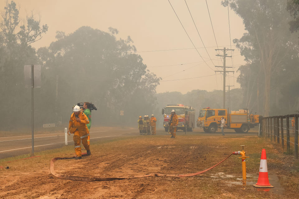 Queensland firefighters seen battling blazes. Source: AAP