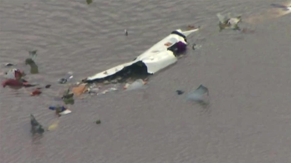 This image taken from video provided by KRIV FOX 26 shows the scene of a cargo plane crash on Saturday, Feb. 23, 2019 in Trinity Bay, just north of Galveston Bay and the Gulf of Mexico in Texas. Lynn Lunsford with the Federal Aviation Administration did not immediately know the status of the people aboard and the Chambers County Sheriff's Office could not immediately be reached for comment. (KRIV FOX 26 via AP)