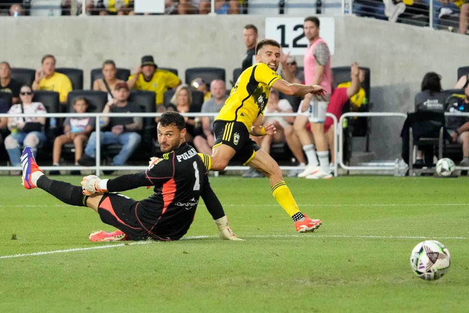 Aug 9, 2024; Columbus, OH, USA; Columbus Crew forward Diego Rossi (10) scores a goal past Sporting Kansas City goalkeeper John Pulskamp (1) during the first half of the Leagues Cup soccer match at Lower.com Field.