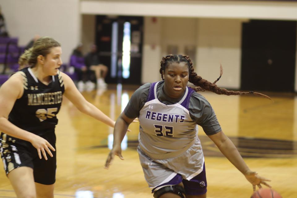 Regent freshman Anaya Davis drives to the basket during an 83-82 victory over Manchester University on Nov. 6, 2021, in Rockford. Davis currently leads the NACC in scoring (17.3 points per game) and rebounding (13.3 rebounds per game).