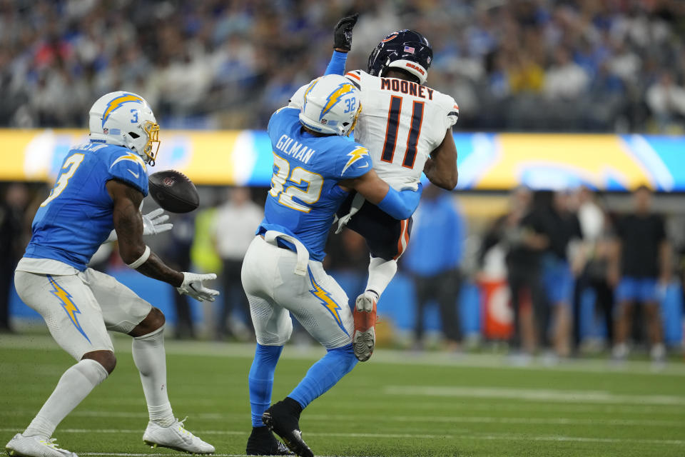 Los Angeles Chargers safety Derwin James Jr., left, intercepts a pass intended for Chicago Bears wide receiver Darnell Mooney, right, as Mooney is hit by Los Angeles Chargers safety Alohi Gilman during the second half of an NFL football game Sunday, Oct. 29, 2023, in Inglewood, Calif. (AP Photo/Ashley Landis)
