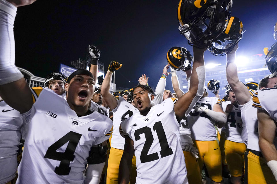 Iowa players celebrate after defeating Maryland 51-14 during an NCAA college football game, Friday, Oct. 1, 2021, in College Park, Md. (AP Photo/Julio Cortez)