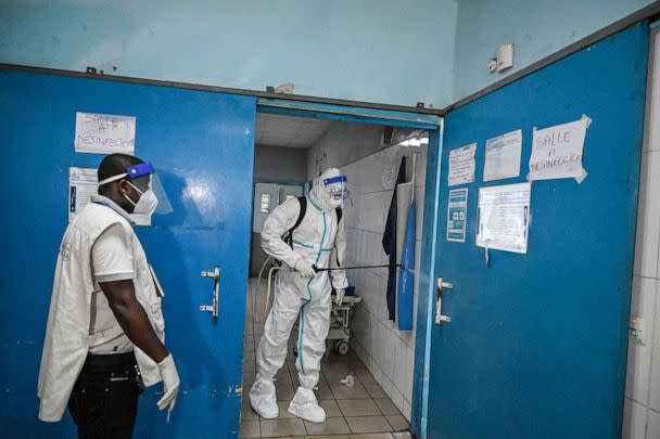 PHOTO: In this Aug. 16, 2021, file photo, an agent of the National Institute of Public Hygiene, wearing a PPE suit against the Ebola virus, disinfects the premises of the hospital in Cocody, Ivory Coast,following the passage of an Ebola patient. (Sia Kambou/AFP via Getty Images, FILE)