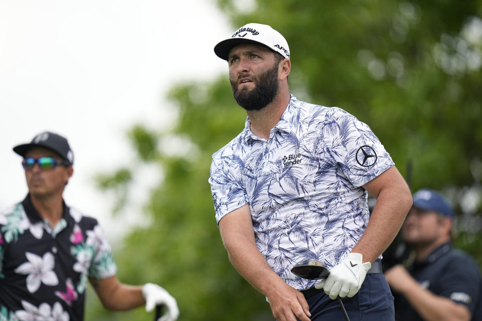 Jon Rahm, of Spain, right, watches his tee shot on the sixth hole during the first round of matches of the WGC-Dell Technologies Match Play golf tournament in Austin, Texas, Wednesday, March 22, 2023.(AP Photo/Eric Gay)