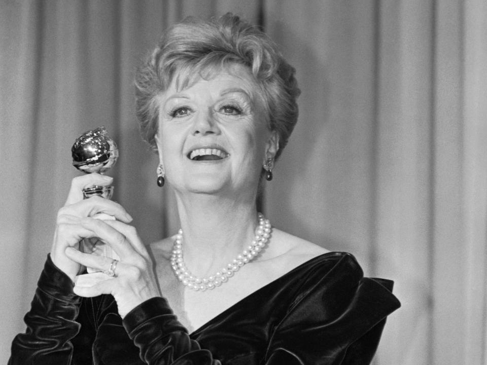 Actress Angela Lansbury holds up her Golden Globe award, which she won for best performance by an actress in a TV-series drama in 1987.