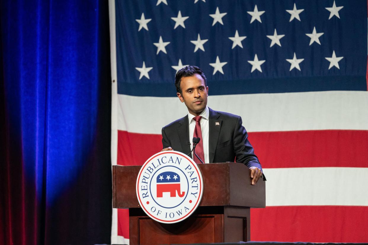 Vivek Ramaswamy speaks at a podium with the seal of the Republican Party of Iowa on it