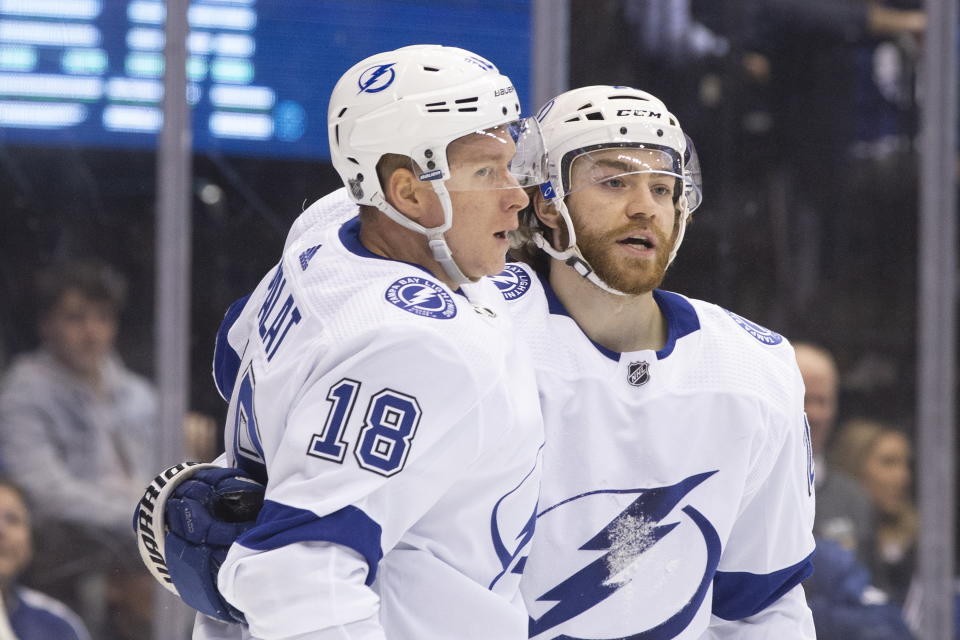 Tampa Bay Lightning left wing Ondrej Palat (18) celebrates with center Brayden Point (21) after scoring against the Toronto Maple Leafs during the second period of an NHL hockey game Tuesday, March 10, 2020, in Toronto. (Chris Young/The Canadian Press via AP)