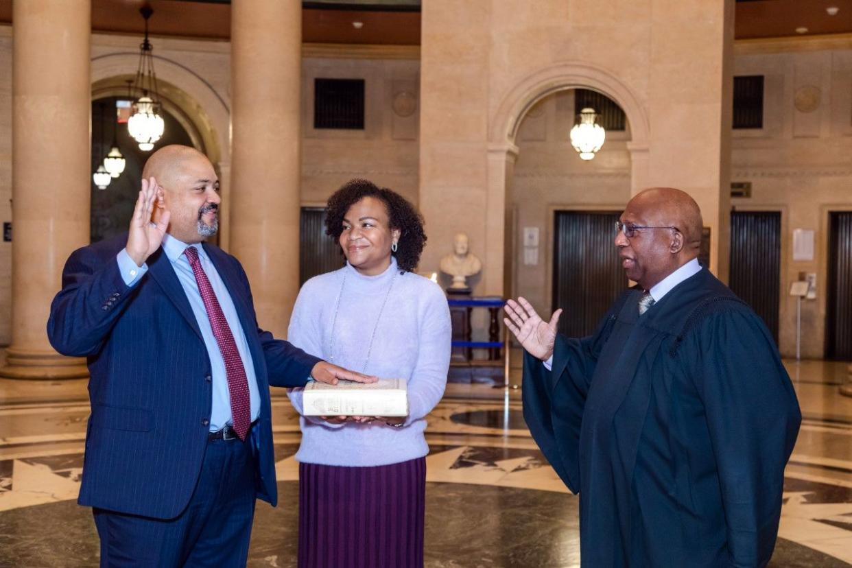 Alvin Bragg (left) being sworn in as Manhattan DA by the Hon. Milton Tingling (right) as his wife, Jamila Ponton Bragg (center) holds a bible at the New York County Courthouse in Manhattan, New York on Friday, Dec. 31, 2021.