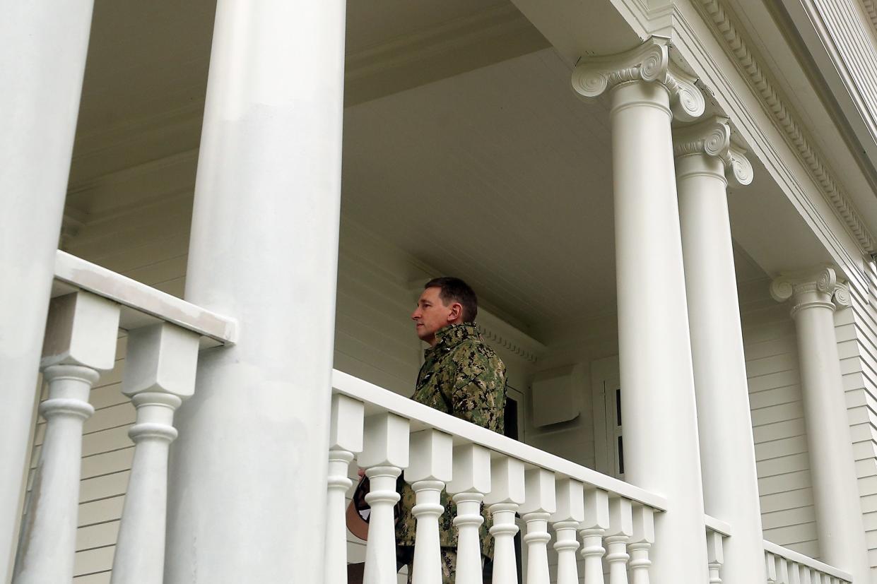 Naval Base Kitsap Commanding Officer Capt. Rich Massie stands among the columns of the front porch of his quarters on Officers Row at Naval Base-Kitsap Bremerton on Dec. 18. The historical home recently had the columns replaced.