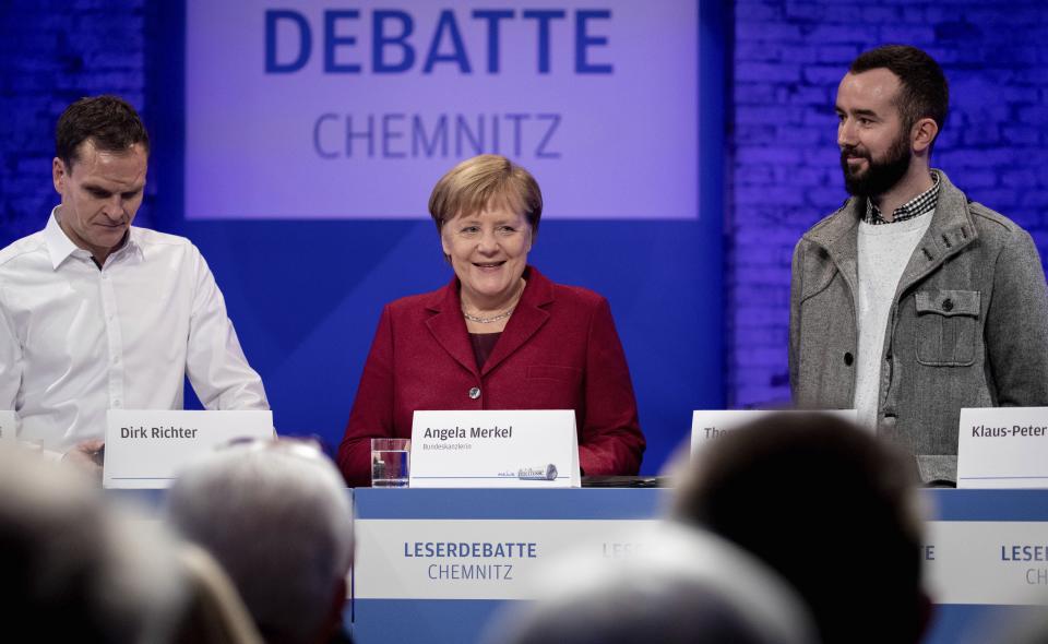 German Chancellor Angela Merkel attends a discussion with citizen at the East German city Chemnitz, Friday, Nov. 16, 2018. (AP Photo/Kay Nietfeld, Pool)