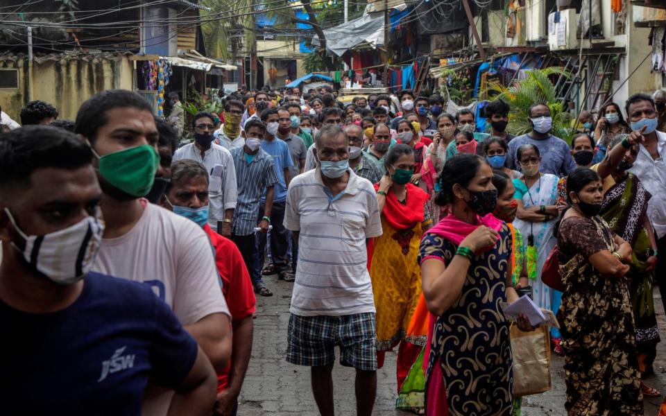 People line up to get inoculated against coronavirus at a vaccination camp in Mumbai, India - Rajanish Kakade/AP