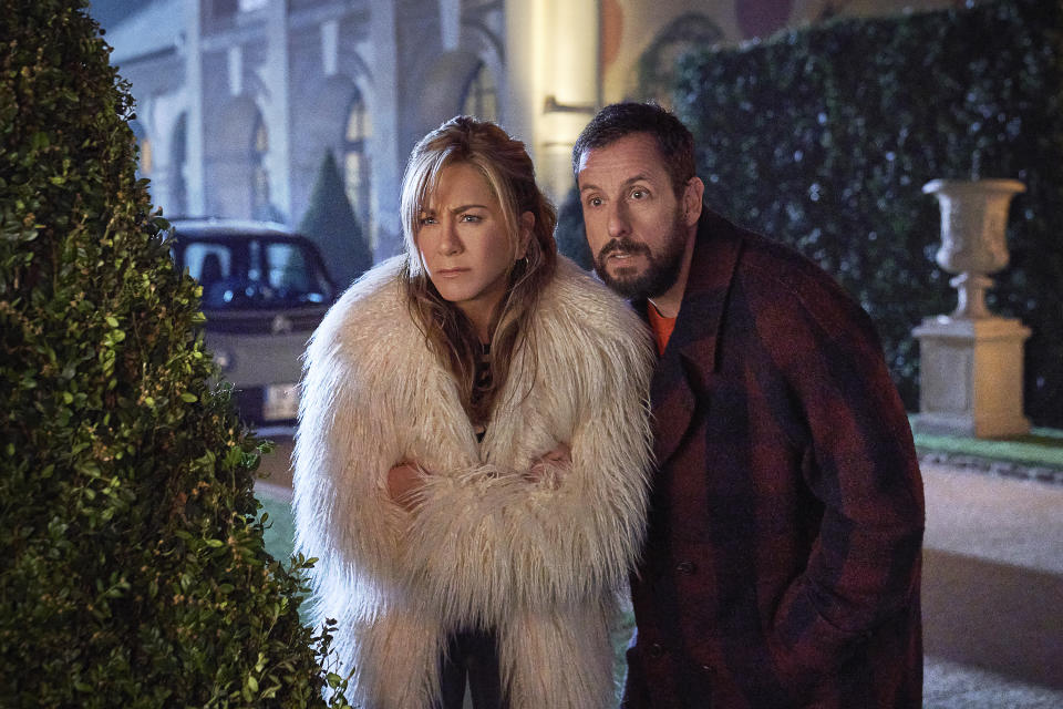 This image released by Netflix shows Jennifer Aniston, left, and Adam Sandler in a scene from the film "Murder Mystery 2." (Scott Yamano/Netflix via AP)