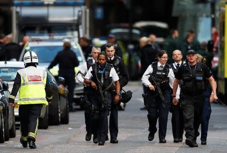 Armed police officers walk outside Borough Market after an attack left 6 people dead and dozens injured in London, Britain, June 4, 2017. REUTERS/Peter Nicholls