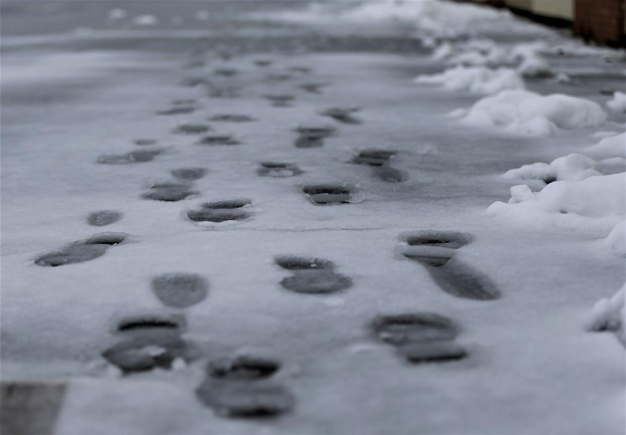Footprints show through wet, mushy snow on a South 4th Street sidewalk Jan. 25, 2023.