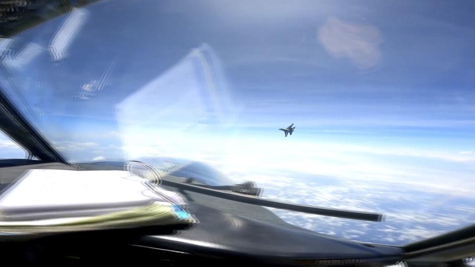 In this image from video provided by the U.S. Navy, a Chinese J-16 fighter flies aggressively close to a U.S. RC-135 aircraft flying in international airspace over the South China Sea on Friday, May 26, 2023. (U.S. Navy via AP)