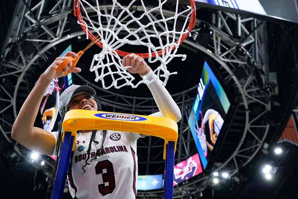 South Carolina's Destanni Henderson cuts the net after a college basketball game in the final round of the Women's Final Four NCAA tournament against UConn Sunday, April 3, 2022, in Minneapolis. South Carolina won 64-49 to win the championship. (AP Photo/Eric Gay)