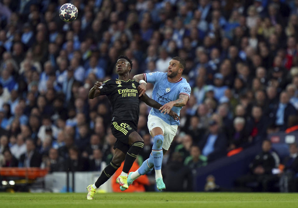 Manchester City's Kyle Walker and Real Madrid's Jose Vinicius Junior, left, battle for the ball during the Champions League semi-final second leg match between Manchester City and Real Madrid, at Etihad Stadium, in Manchester, England, Wednesday May 17, 2023. (Tim Goode/PA via AP)