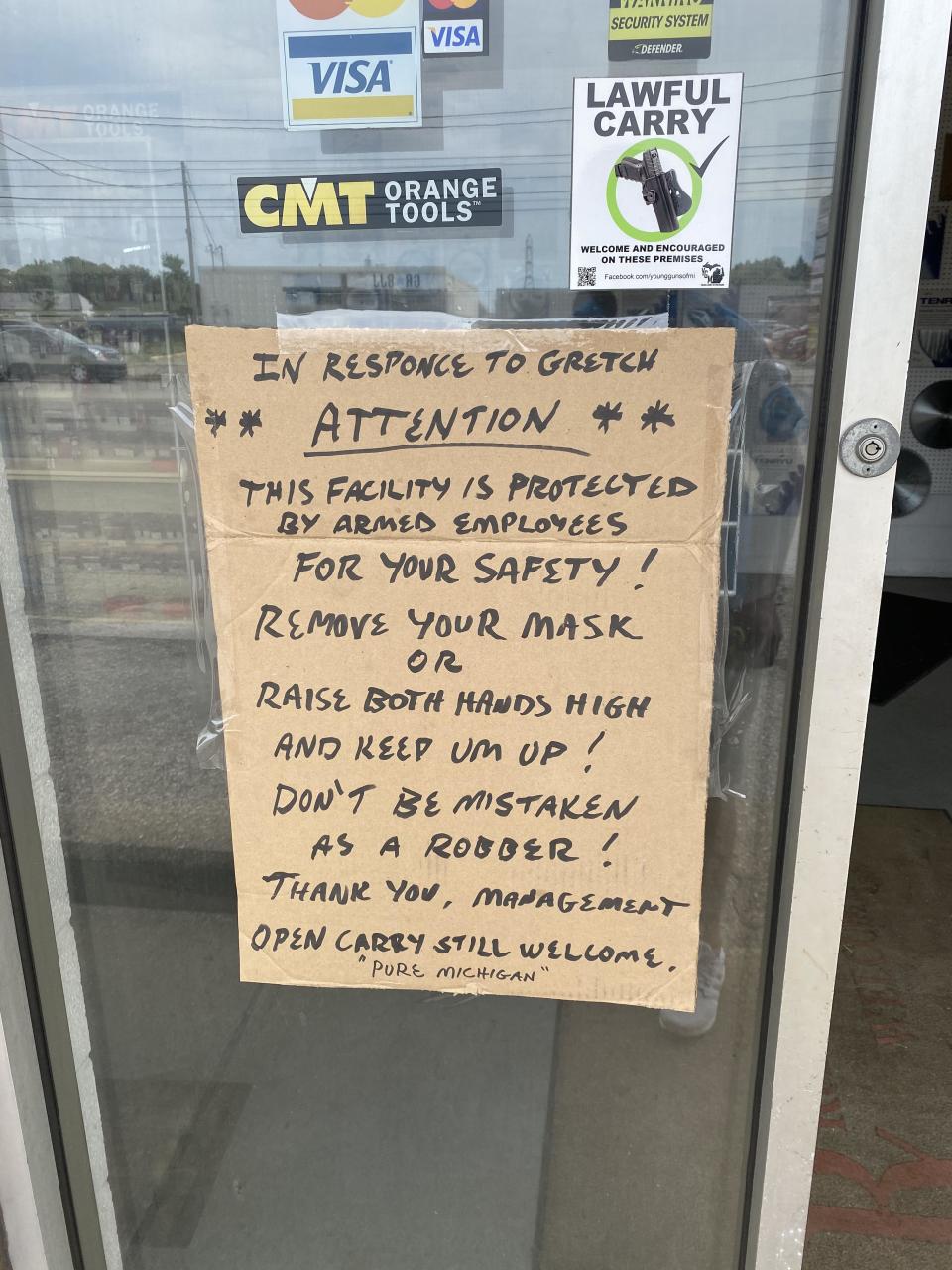 A sign in front of Tubergen Cutting Tools Inc. in Kentwood, Mich. implies customers who wear masks will be treated as criminals, on Tuesday, July 14. The owner of the metal-cutting shop said the sign is meant as a display of humor.