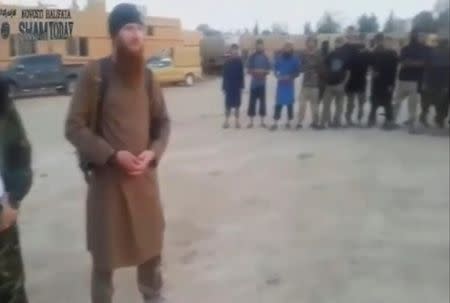 A still image taken on July 14, 2016 from an undated video posted on social media, shows Islamic State senior operative Abu Omar al-Shishani stands with fighters in Al Hasakah, Syria. Social Media